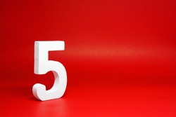 Five ( 5 ) white number wooden Isolated Red Background with Copy Space - New promotion 5% Percentage  Business finance Concept 