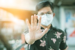 Coronavirus or (COVID-19) and PM2.5 air pollution with epidemics and deadly contagious concepts Asian men wear surgical masks and use their hands to act to stop or stop the outbreak of new contagious.