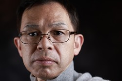Middle-aged Japanese man in gray turtleneck wool sweater. Concept image of Warm Biz, stability in daily life, and sustainable living.