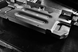 Car parts Produced by Accurate Sheet Metal Stamping Tool Die. Black-and-white photo.