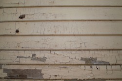 Cracking paint on my 100 year old house. Shows the wears and tears of living on a farm.