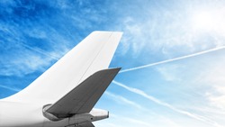 modern airplane tail isolated on cloud sky background side view of commercial passenger jet aircraft with wide body cargo plane parts like white fuselage fin wing air travel copy space template