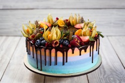 Chocolate cupcakes with colored layers decorated  by fruit, berries and candy as birthday concept