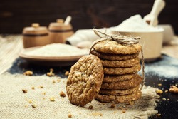 Domestic stacked biscuit sweet cookie with the sesame,peanuts,sunflower background on wooden table close up 