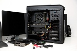 Building of PC, ATX motherboard and computer power supply unit inserted to black midi tower case