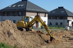 Crawler excavator on the construction site - work on the construction of the house has started