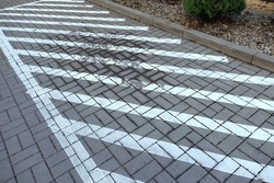 Diagonal lines painted with paint on the road informing about the prohibition of parking in this area