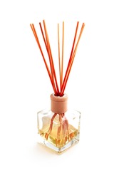 Home perfume in a glass bottle with wooden sticks. Elegant spa decoration, luxury air fresher, Asian style.