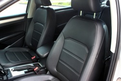 Interior of prestige modern car. Comfortable leather seats. The driver and front passenger seat of a luxury business class car. Luxury car inside. Black leather cockpit.