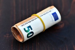 Roll of 1000 Euro in 50 Euro banknotes. Stack of money of Europe. Bunch of euro money. Stack of 50 euro