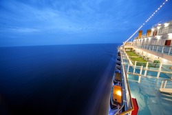 cruise ship floats at night, long exposure