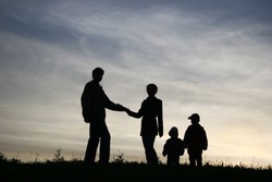 man take woman with two children. silhouette