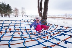 five-year-old girl playing in the Park on the rope trampoline