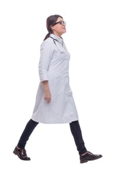 Female doctor walking towards the camera smiling isolated over a white background