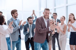 young businessman on the background of applauding business team.