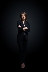 Full-length portrait of businesswoman  isolated on black background