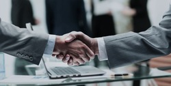 business partners shake hands after a meeting on the background 