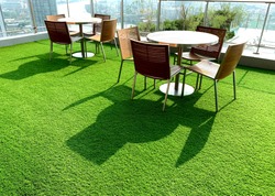Terrace, Cushion made of fabric and furniture outdoor table set. Placed on an artificial green grass, table set for dining decorating with artificial grass circle shape on the floor.