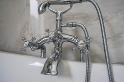 stainless hot and cold faucet with shower at bath tab in luxury hotel for honeymoon
