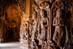 Wooden sculptures of goddesses in Hindu and Buddhism religions, reflecting traditional religious themes. 
