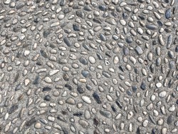 Texture of a stone road. Old paved road background texture. Part of a stone street, for background or texture