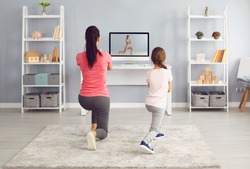 Fitness video course online. Family watching fitness training exercises online sports trainer course using video computer