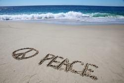 Words Written in the sand. The word PEACE written in the sand with the ocean in the background. Peace around the world. Peace and Love. Peace. 