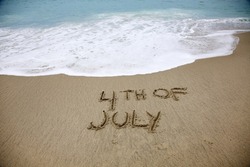 4th of July Words written in sand. Laguna Beach, California with 4th of July words in the sand. Pacific Ocean in Laguna Beach Ca. Fourth of July Text hand written into the sand in Laguna Beach CA. 