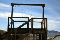 a gallows in a real ghost town in nevada usa with two nooses bringing to light the reality of Swift Justice from the Wild Wild West