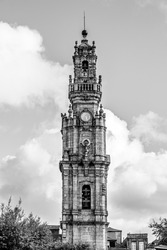 Porto, Portugal: The Clerigos tower; baroque medieval  tower of Clerigos church on white clouded sky background in blacck and white