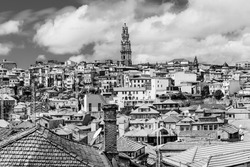 Porto, Portugal: Old town skyline with Clerigos tower and old houses roof tops in black and white