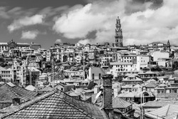 Porto, Portugal: Old town skyline with Clerigos tower and old houses roof tops in black and white as seen from the cathedral