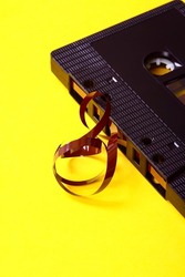Old vintage retro audio cassette tape after a tape jam where the magnetic tape has unravelled