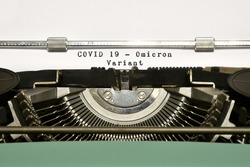 Covid-19 new Omicron variant. Conceptual words Covid 19 Omicron Variant typed on vintage typewriter. Omicron (B.1.1.529): SARS-CoV-2 Variant of Concern