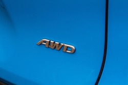 AWD emblem on modern black SUV car detail close up view. All Wheel Drive chrome badge.