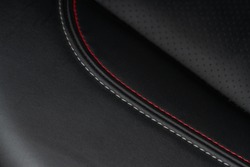 High angle view of modern car fabric seats. Close-up car seat texture and interior details. Detailed image of a car pleats stitch work. Leather seats.
