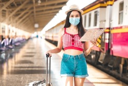 Woman traveler with bag, luggage, arrival  traveling, travel, trip for woman concept, say hi, good bye to friend..trip in summer with face mask for protection by infection from Coronavirus, Covid-19