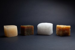 four multi-colored cubes synthetic rubber samples on a black background shot close in the studio