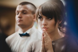 Young girl is praying in the church