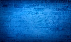 Blue brick wall background. Monotone texture of a flat brick wall close-up.