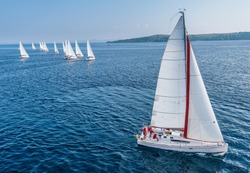 Racing sail boat from bird view, many of sailing boats in background