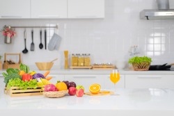 Orange juice is placed on a white table, orange juice, bright colors placed on the table and the atmosphere in the kitchen is clean white.