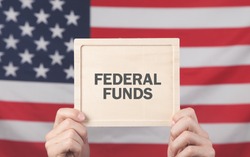 Male hands showing Federal Funds text.