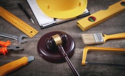 Judge gavel, safety helmet and working tools. Construction Law
