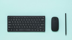 Keyboard, mouse and black pencil on a light background. Peripheral devices for computers.