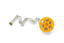 Yellow measuring tape on a coil isolated on a white background. A device for measuring body parameters. Flat lay.