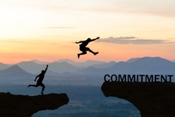 Men jump over silhouette failure commitment to success