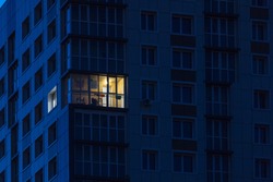 the light burns in one window of the multitude in a multi-storey residential building
