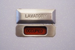Occupied lavatory sign on the commercial airlines.