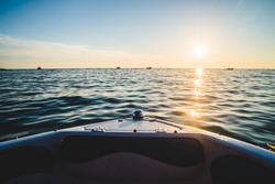 Beautiful boat ride, sunset seen from a motorboat in the Adriatic Sea, Croatia. Relaxing peaceful moment on the waves.